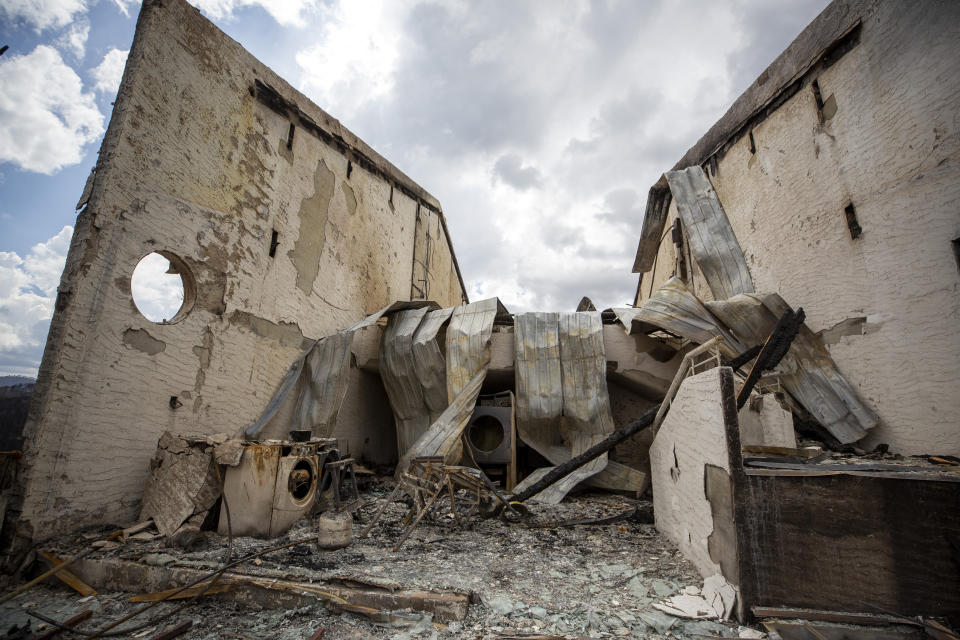 The remains of the Swiss Chalet Hotel are pictured after it was destroyed by the South Fork Fire in the mountain village of Ruidoso, N.M., Saturday, June 22, 2024. (AP Photo/Andres Leighton)