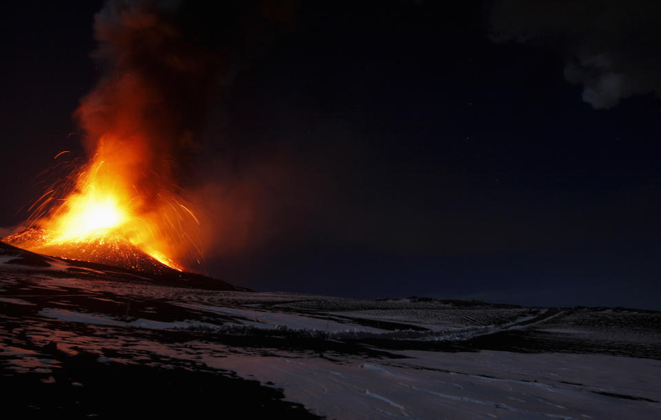 Italy's Mount Etna, Europe's tallest and most active volcano, spews lava as it erupts on the southern island of Sicily November 17, 2013. There were no reports of damage or evacuations in the area and the nearby airport of Catania was operating as normal, local media reported. It is the 16th time that Etna has erupted in 2013. The south-eastern crater, formed in 1971, has been the most active in recent years.    REUTERS/Antonio Parrinello (ITALY - Tags: ENVIRONMENT SOCIETY)