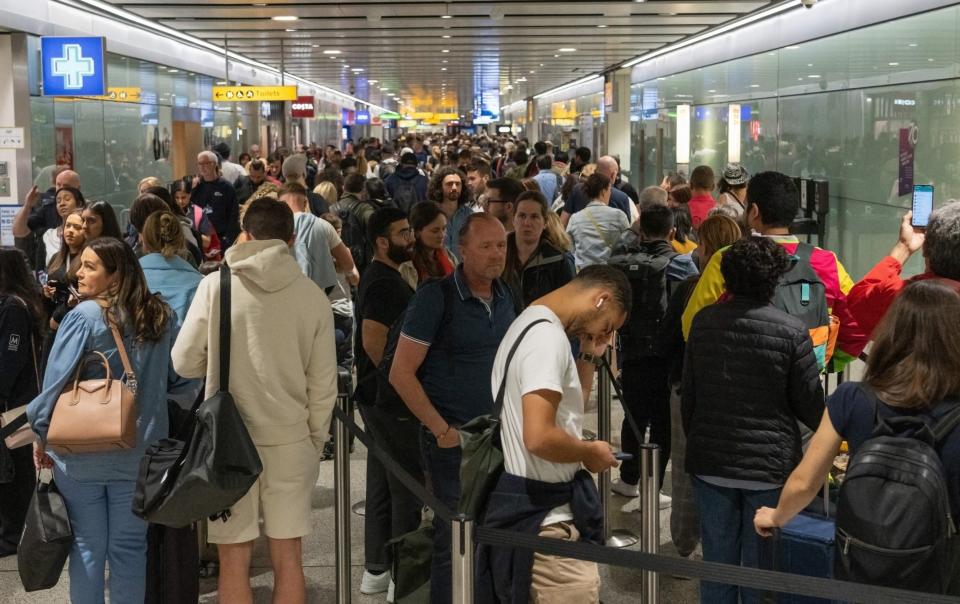 Travellers wait in a long queue to pass through the security check at Heathrow on June 1, 2022 in London, England - Carl Court/Getty