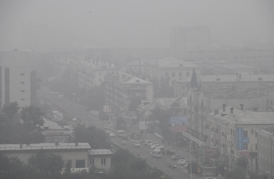 Heavy smoke covers the center of the eastern Siberian city of Chita, Russia, Thursday, Aug. 1, 2019, as Russian Prime Minister Dmitry Medvedev visits the region. Russian authorities have declared a state of emergency in five areas, including all of the Irkutsk and Krasnoyarsk regions, which lie north of Mongolia. (AP Photo)