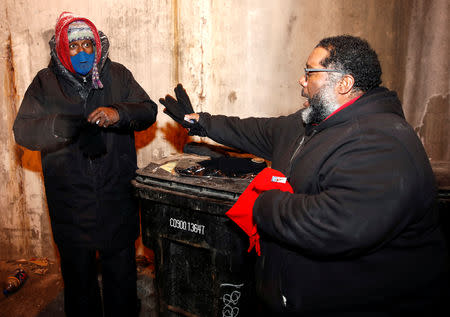 Richard S. Vargas, The Salvation Army Director of Community Social Services, presents to homeless Alvin Henry new pair of gloves during cold wellness checkup in Chicago, Illinois, U.S., January 31, 2019. REUTERS/Kamil Krzaczynski