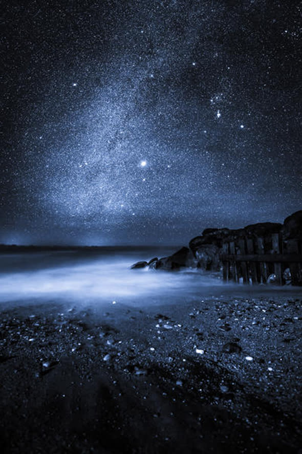 ISLE OF WHITE, GREAT BRITAIN - JANUARY 17 A view of the Milky Way taken by Chad Powell on a DSLR camera on January 17, 2015. Framed here in the sky is the fainter part of the milky way's centre, which is home to Orion as well as Sirius, the brightest star in our night sky.  LIGHTS from the Milky Way dazzle above the Isle of White in these rarely seen British sky-scapes. Chad Powell captured images of spectacular light patterns above the familiar beach scenes of England?s largest island. The 23-year-old used a DSLR camera to enhance the Milky Way from the white strip visible to the naked eye into an explosion of colourful lights. The graphic designer from Ventnor, Isle of Wight, used the local architecture, coves and plant life of the island in the foreground of his photographs to create a contrast with the dramatic sky. Wheat fields, night daisies and a medieval lighthouse are some of the scenes Chad captures against the startling natural light displays.  PHOTOGRAPH BY Chad Powell / Barcroft Media  UK Office, London. T +44 845 370 2233 W www.barcroftmedia.com  USA Office, New York City. T +1 212 796 2458 W www.barcroftusa.com  Indian Office, Delhi. T +91 11 4053 2429 W www.barcroftindia.com