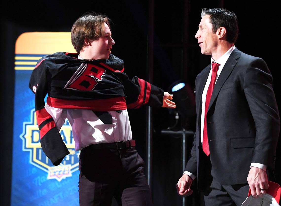 Carolina Hurricanes draft pick Bradly Nadeau talks with head coach Rod BrindAmour after being selected with the thirtieth pick in round one of the 2023 NHL Draft at Bridgestone Arena.