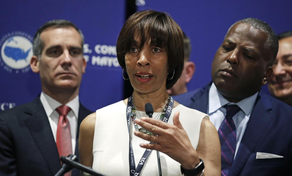 FILE - In this June 8, 2018 file photo, Baltimore Mayor Catherine Pugh addresses a gathering during the annual meeting of the U.S. Conference of Mayors in Boston.When Bernard “Jack” Young automatically became Baltimore’s acting mayor on April 1, he emphasized that he’d act only as a “placeholder” for the embattled elected mayor. But it’s been more than three weeks since Mayor Catherine Pugh slipped out of sight on an indefinite leave of absence, and it appears Young is settling in for a lengthy stint as Baltimore’s No. 1 official. (AP Photo/Charles Krupa, File)