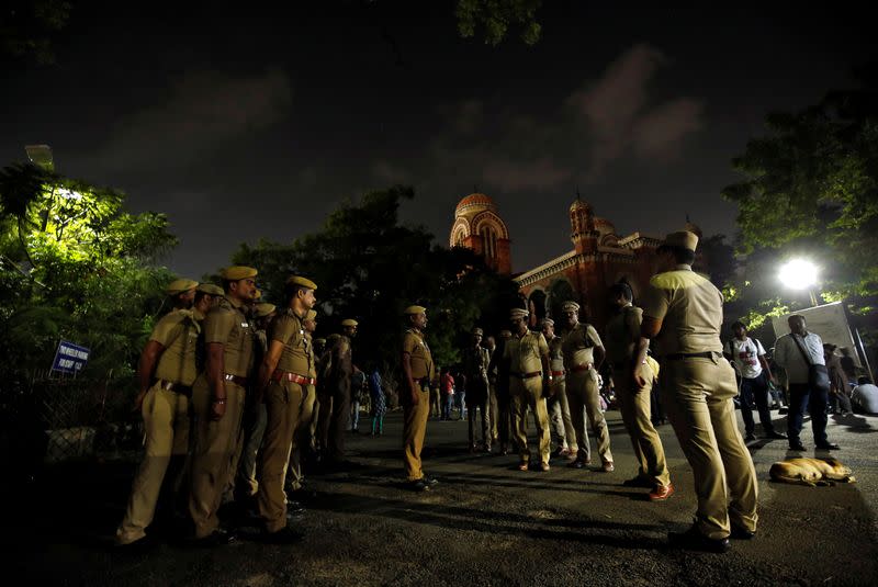 Police stand guard inside a Madras university compound during a protest by the university students against a new citizenship law and to show solidarity with the students of New Delhi's Jamia Millia Islamia university, in Chennai
