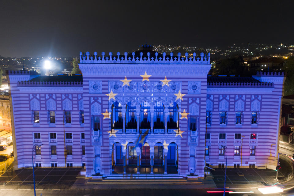 FILE - The European Union flag is projected on the National Library building in Sarajevo, Bosnia, on Oct. 12, 2022. The war in Ukraine has put the European Union's expansion at the top of the agenda as officials from the Western Balkans and EU leaders gather Tuesday for a summit intended to reinvigorate the whole enlargement process. (AP Photo/Armin Durgut, File)