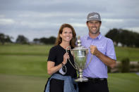 Robert Streb, right, and his wife Maggie Streb hold the trophy after a winning a second hole playoff against Kevin Kisner at the RSM Classic golf tournament, Sunday, Nov. 22, 2020, in St. Simons Island, Ga. (AP Photo/Stephen B. Morton)