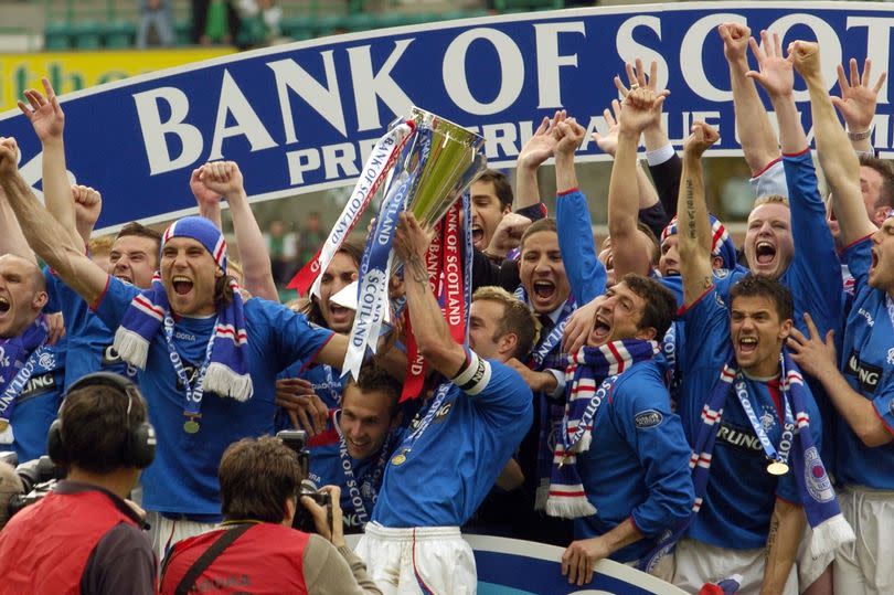 Fernando Ricksen lifts the Scottish Premier League trophy after beating Hibs on Helicopter Sunday in 2005 -Credit:Daily Record