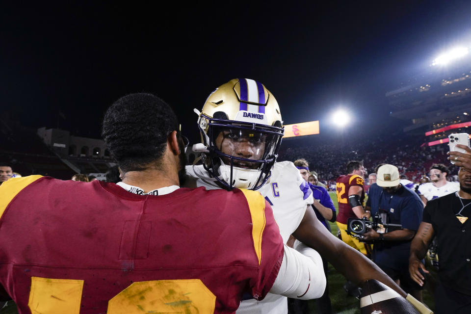 Washington quarterback Michael Penix Jr., right, hugs Southern California quarterback Caleb Williams after an NCAA college football game Saturday, Nov. 4, 2023, in Los Angeles. (AP Photo/Ryan Sun)