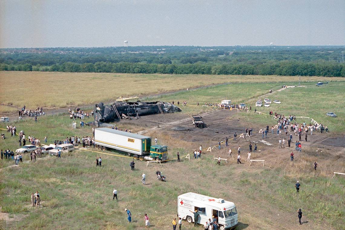 Aug. 31, 1988: An aerial view of the Delta Flight 1141 plane crash at Dallas-Fort Worth International Airport. A Red Cross van is seen parked near the scene of the wreckage. The deceased were placed in the makeshift refrigerated morgue transport truck, set up on site by the Tarrant County Medical Examiner’s Office. The Boeing 727 struck an antenna array about 1,000 feet beyond the end of runway 18L and came to rest about 3,200 feet beyond the end of the pavement.
