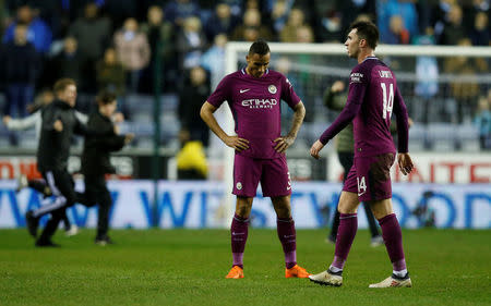 Soccer Football - FA Cup Fifth Round - Wigan Athletic vs Manchester City - DW Stadium, Wigan, Britain - February 19, 2018 Manchester City's Danilo and Aymeric Laporte look dejected after the match REUTERS/Andrew Yates