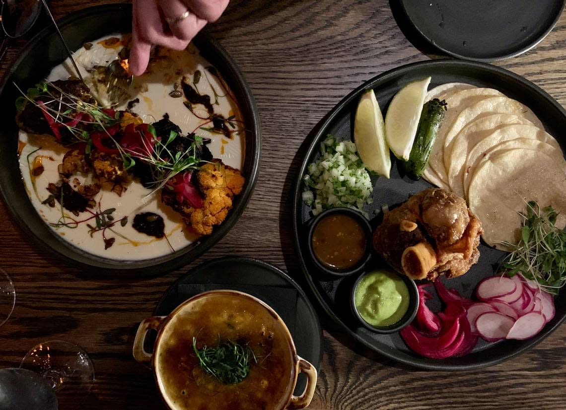 Rey Carbon centers on carefully sourced steak, but accompaniments intrigue. On left, whole-roasted cauliflower in a queso-fundido sauce. On right, the carnitas taco plate, and, below, the cream corn brûlée.