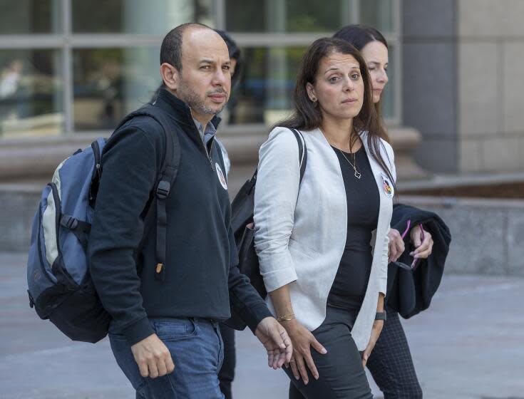 VAN NUYS, CA-APRIL 25, 2022: Nancy Iskander and her husband Karim leave Van Nuys Courthouse during a lunch break from a preliminary hearing for Rebecca Grossman who is charged with murder and other counts stemming from a crash in Westlake Village that left the Iskander's sons Mark Iskander, 11, and Jacob Iskander, 8, dead. Nancy Iskander took the witness stand and testified to the moment her sons were killed by Grossman's Mercedes as they were walking in the crosswalk on Triunfo Canyon Rd. In. Westlake. Village. (Mel Melcon / Los Angeles Times)