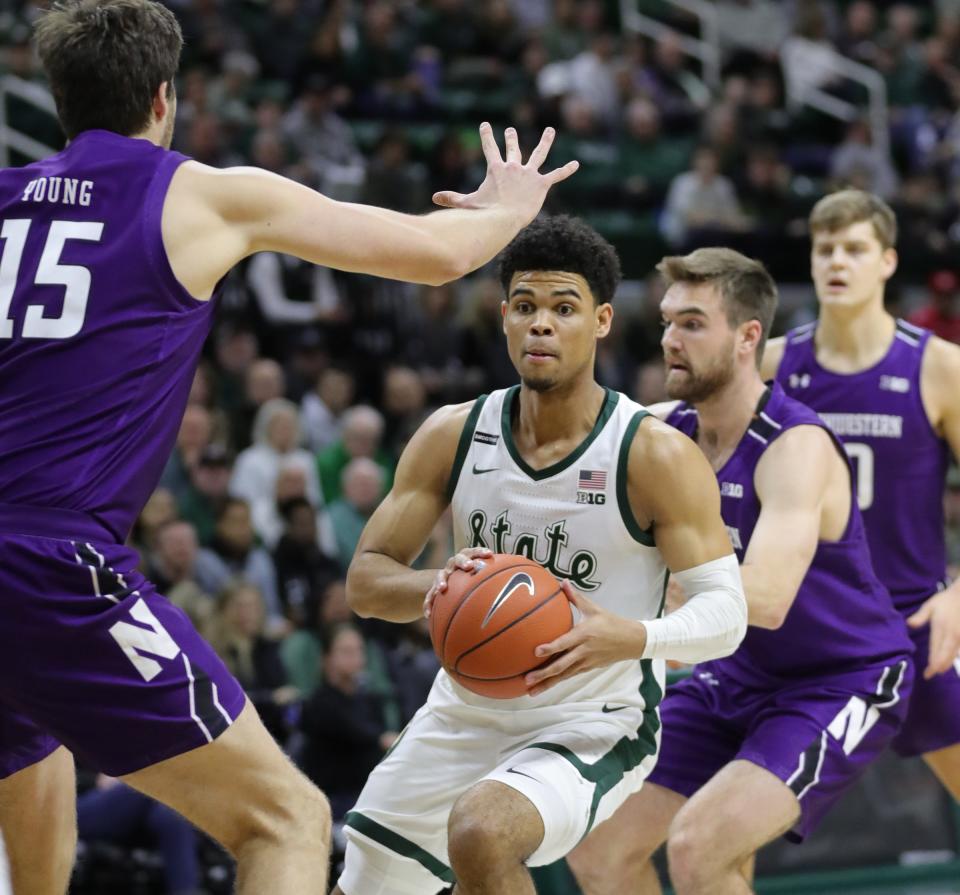 Michigan State guard Malik Hall passes against Northwestern center Ryan Young during the first half of MSU's 79-50 win on Wednesday, Jan. 29, 2020, at the Breslin Center.