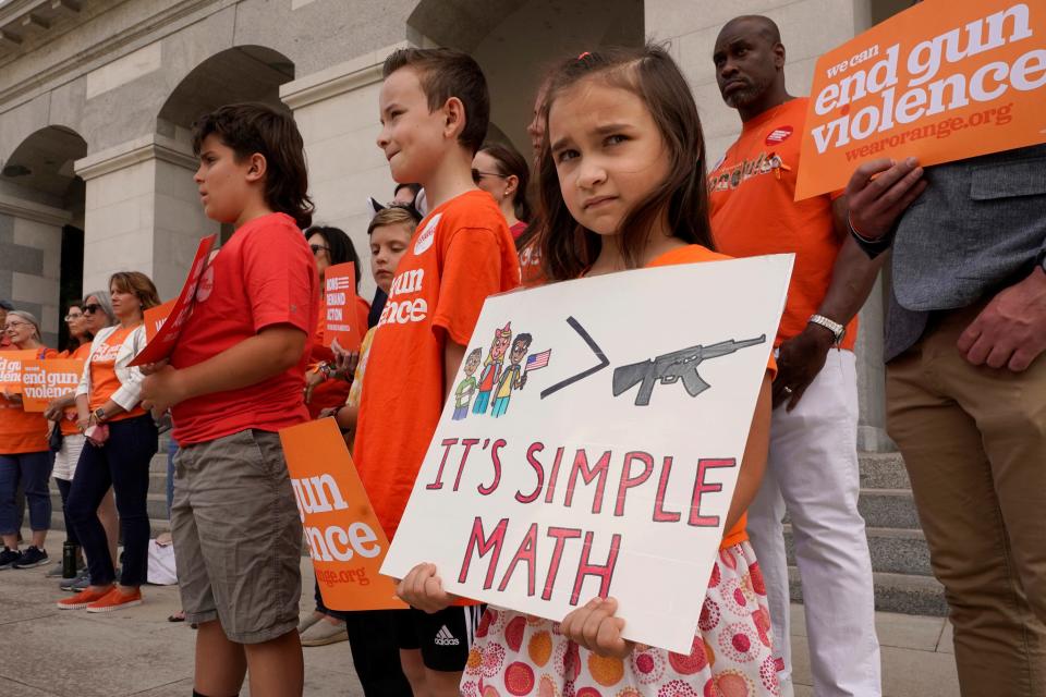 Elise Schering, 7, displays a message during a National Gun Violence Awareness rally at the Capitol in Sacramento, Calif., on Thursday, June 2, 2022. California is spending $11 million on education programs promoting wider use of "red flag" orders.