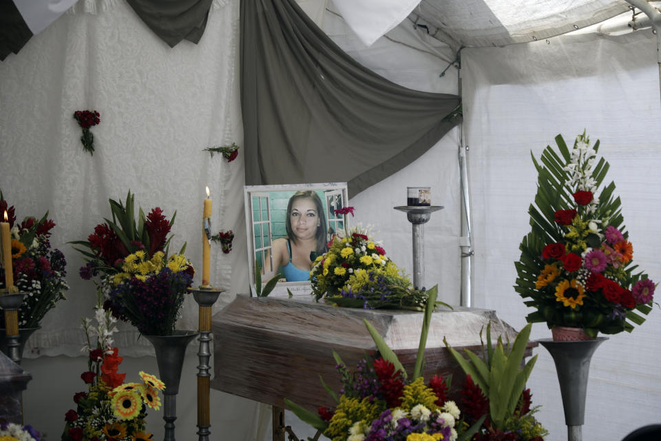 A photograph of Karla Euseda sits on top her coffin in Tegucigalpa, Honduras, Thursday, June 22, 2023. Euseda and her mother died in a riot on June 20 at a women's prison northwest of the Honduran capital that killed at least 46 inmates, many of them burned, shot or stabbed to death, according to police. (AP Photo/Elmer Martinez)