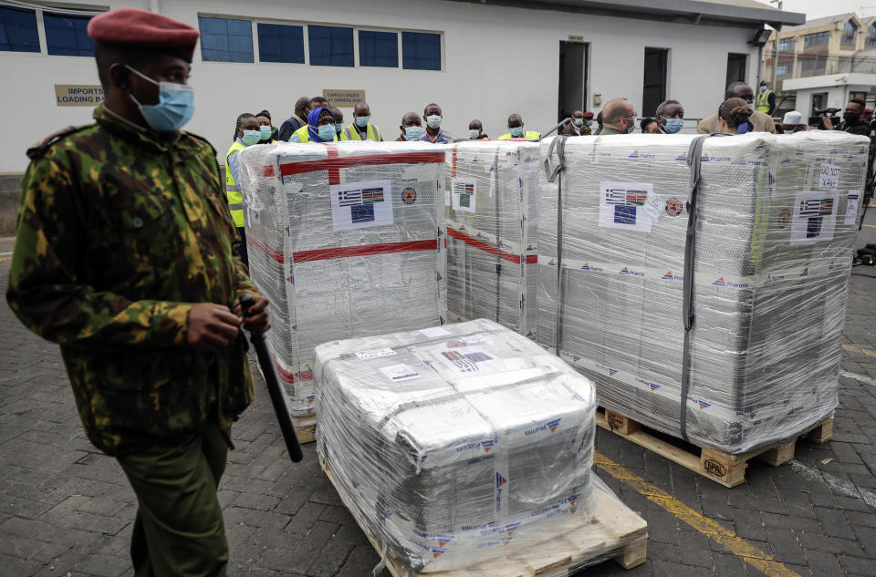 FILE - In this file Friday, Aug.6. 2021 file photo, a Kenyan soldier guards a consignment of 182,000 AstraZeneca vaccines from the Greek Government via the COVAX facility, at Kenya Jomo Kenyatta airport in Nairobi. In late June, the international system for sharing coronavirus vaccines sent about 530,000 doses to Britain – more than double the amount sent that month to the entire continent of Africa. It was the latest example of how a system that was supposed to guarantee low and middle-income countries vaccines is failing, leaving them at the mercy of haphazard donations from rich countries.(AP Photo/Brian Inganga, file)