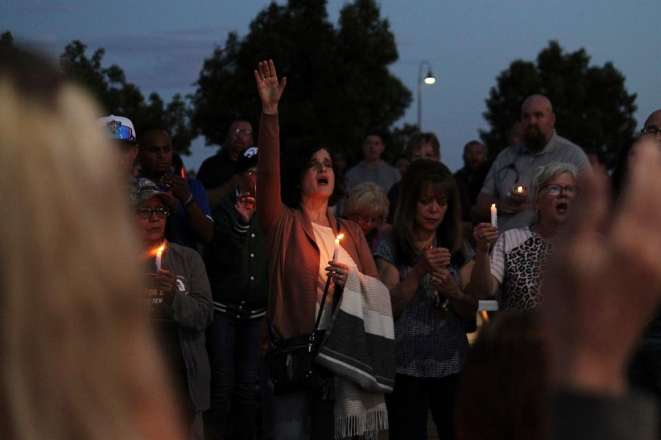 Community members sing during a prayer vigil at Hills Church on Monday in Farmington, N.M.