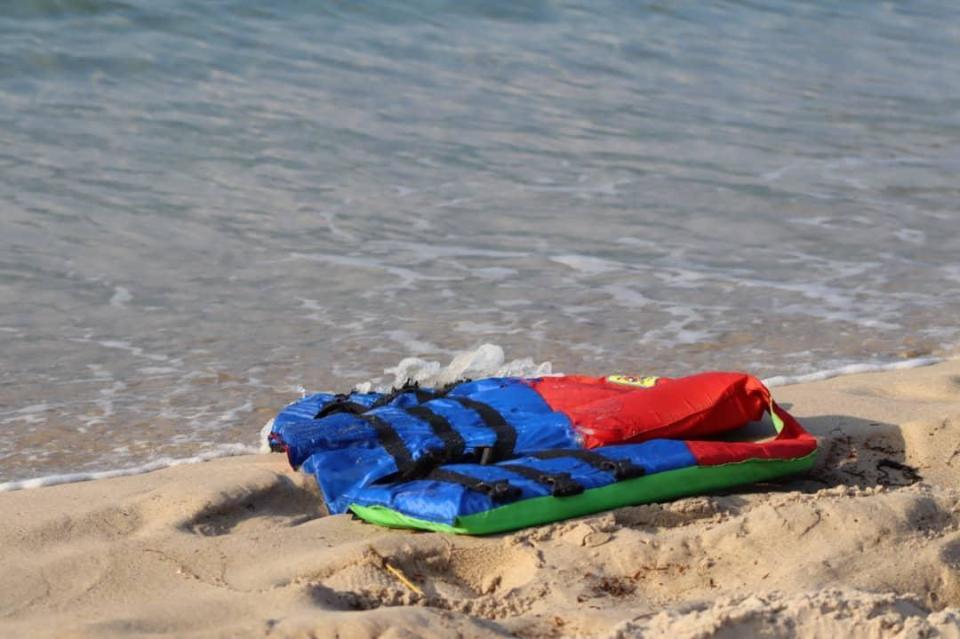 In these photos taken Nov. 12, 2020, life jackets litter the beach off the coast of Libya near the port of al-Khums. Several migrants drowned after their Europe-bound ship broke down off the coast of Libya on Thursday, the U.N. migration agency said, in the latest in a series of at least eight shipwrecks in the Central Mediterranean since last month. (Hussein Ben Mosa/ IOM 2020 via AP)