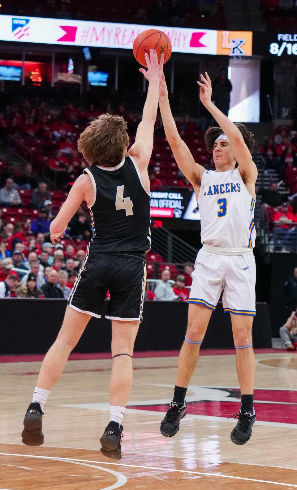 Kenosha St. Joseph's Eric Kenesie (3) elevates for three during the WIAA Division 4 state boys basketball championship against Luther at the Kohl Center in Madison on Saturday, March 18, 2023.