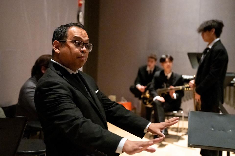 Julius Tolentino conducting, Jacob Tolentino in the background standing, Jason Mo sitting, and Ethan Freed in the far back