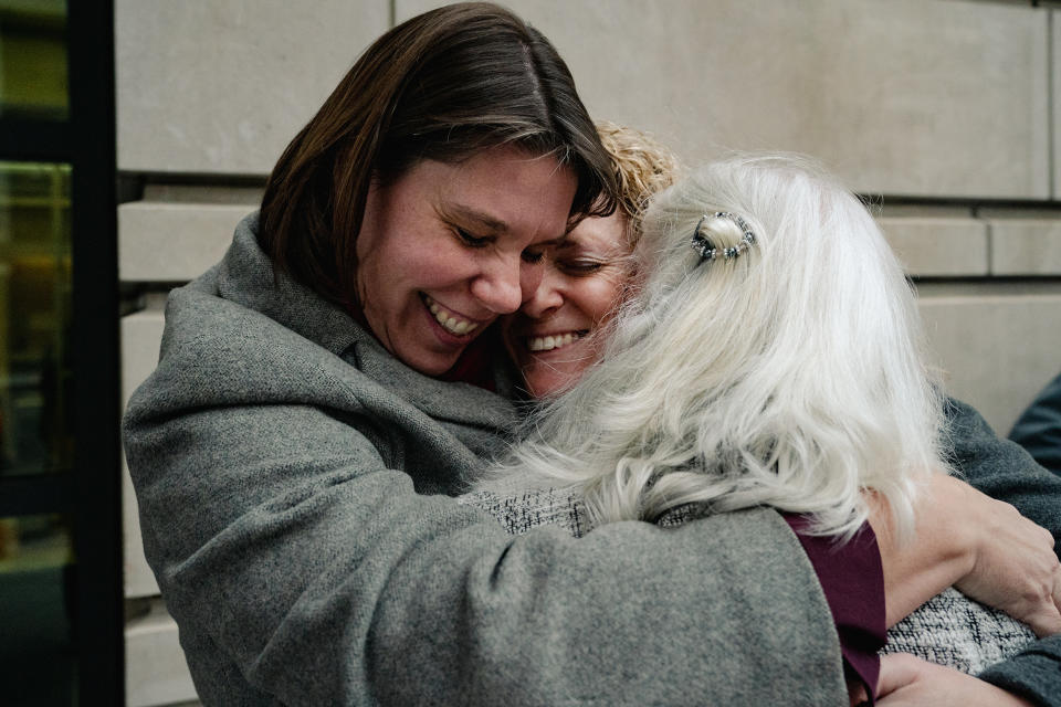 Nicole Enfield, left, hugs Emily Paterson and Rolande Baker on Jan. 13, 2023 after they got probation for disrupting a Supreme Court hearing. (Shuran Huang / For NBC News)