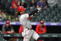 Cincinnati Reds' Jonathan India follows through on a three-run home run off Colorado Rockies relief pitcher Mychal Givens during the eighth inning of a baseball game Thursday, May 13, 2021, in Denver. (AP Photo/David Zalubowski)