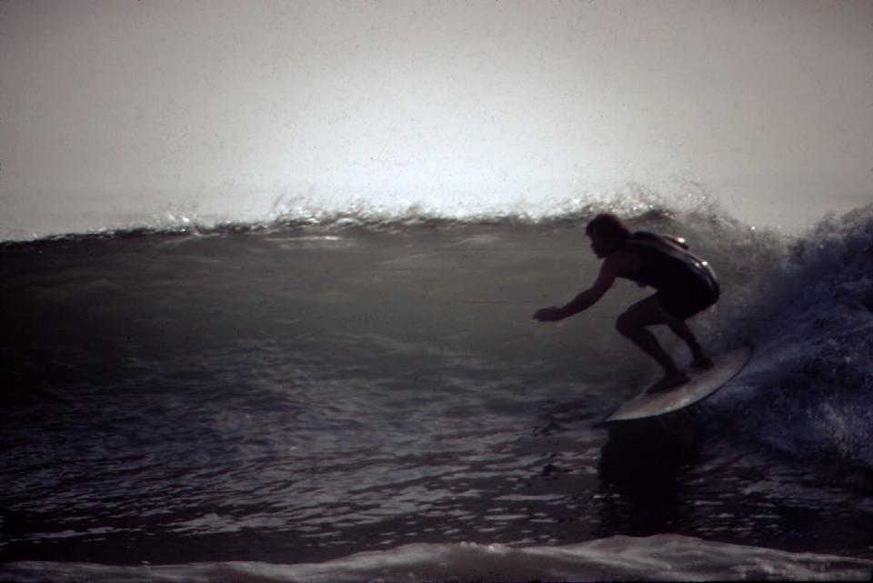 A photo from 1972 shows Bill "Blinky" Hubina, owner of Ventura Surf Shop, surfing at Solimar Beach. Hubina, 79, has been shaping boards since the 1960s.