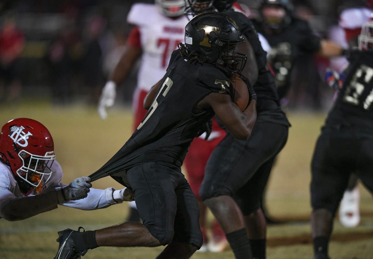 Treasure Coast HIgh School's Demari Scott fights to get into the end zone to score in against Vero Beach in the 4th quarter ar the South County Stadium on Saturday, Oct. 28, 2023, in Port St. Lucie. Treasure Coast won 22-10.