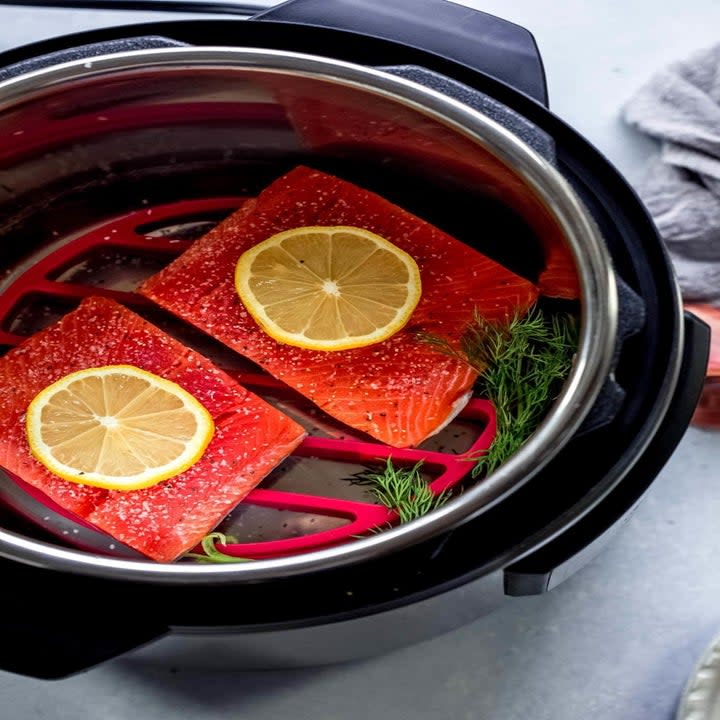 Two pieces of salmon in the basket of an Instant pot