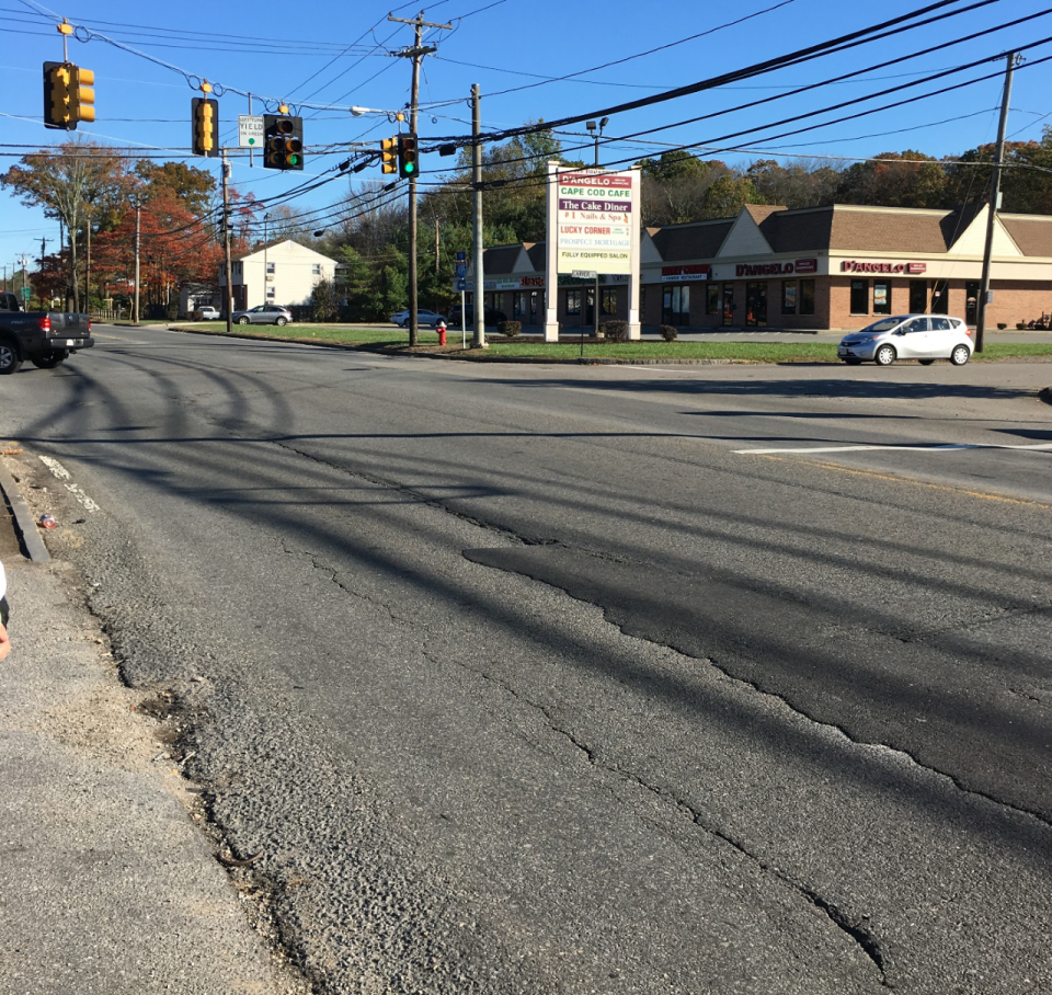 This MassDOT photo shows "poor pavement and missing markings" at the Carver Street intersection looking north on Route 138 in Raynham.