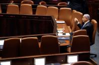 Israeli Prime Minister Benjamin Netanyahu looks on during a special session of the Knesset, Israel's parliament, to approve and swear-in a new coalition government, in Jerusalem