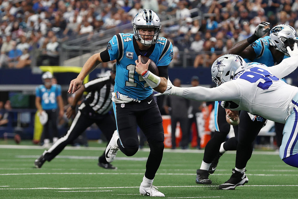 ARLINGTON, TEXAS - OCTOBER 03: Sam Darnold #14 of the Carolina Panthers scrambles and runs passed Quinton Bohanna #98 of the Dallas Cowboys for a touchdown during the second quarter at AT&T Stadium on October 03, 2021 in Arlington, Texas. (Photo by Tom Pennington/Getty Images)