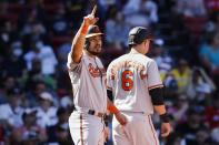 Baltimore Orioles' Anthony Santander signals after scoring with Ryan Mountcastle (6) on a single by Austin Hays during the third inning of a baseball game against the Boston Red Sox, Sunday, Sept. 19, 2021, in Boston. (AP Photo/Michael Dwyer)