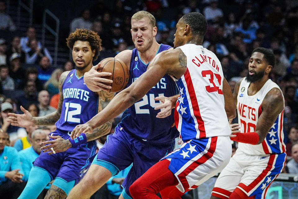Charlotte Hornets center Mason Plumlee (24) drives in to the lane against Brooklyn Nets forward Nic Claxton (33) during the first half of an NBA basketball game, Saturday, Nov. 5, 2022, in Charlotte, N.C. (AP Photo/Rusty Jones)