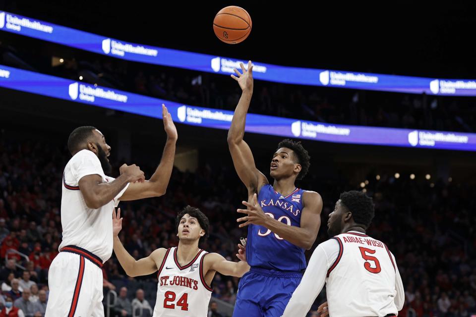 Kansas guard Ochai Agbaji (30) shoots next to St. John's guard Rafael Pinzon (24) during the first half of an NCAA college basketball game Friday, Dec. 3, 2021, in Elmont, N.Y. (AP Photo/Adam Hunger)