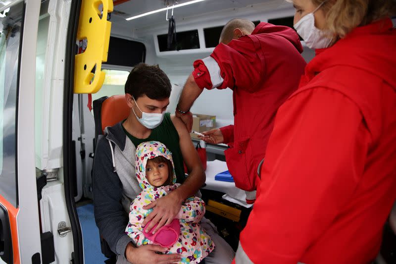 FILE PHOTO: People receive coronavirus disease (COVID-19) vaccine in Krushovitsa