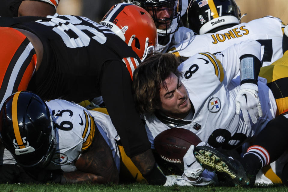 Pittsburgh Steelers quarterback Kenny Pickett (8) is tackled by Cleveland Browns defensive tackle Jordan Elliott (96) during the second half of an NFL football game, Sunday, Nov. 19, 2023, in Cleveland. (AP Photo/Ron Schwane)