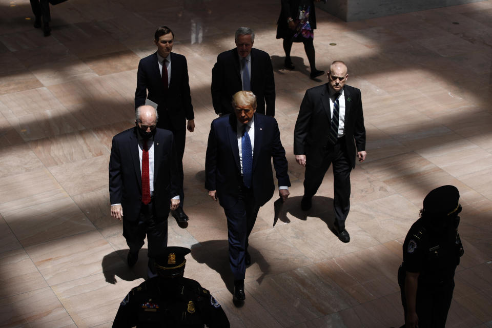 President Donald Trump arrives at the Hart Senate Office Building on Capitol Hill in Washington before meeting with Republican Senators at their weekly luncheon, Tuesday, May 19, 2020. Following Trump are White House Senior Adviser Jared Kushner, top left, and White House chief of staff Mark Meadows. (AP Photo/Patrick Semansky)