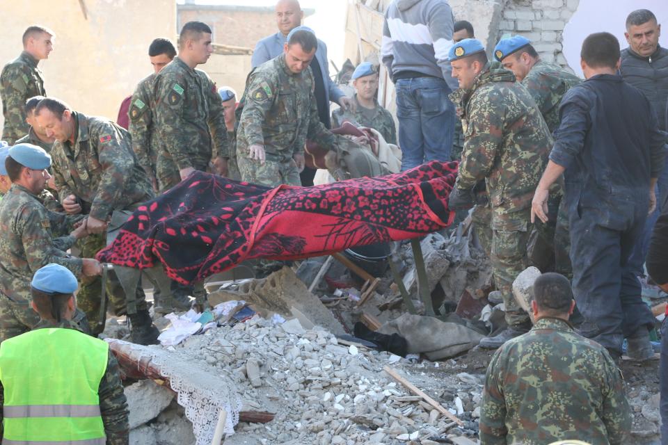 Soldiers carry a dead body pulled out from debris after 6.4-magnitude earthquake hit Albania's Durres city on November 26, 2019. (Photo: Olsi Shehu/Anadolu Agency via Getty Images)