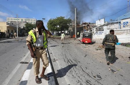 Somali policemen secure the scene of an explosion near Waberi police station station in Mogadishu, Somalia June 22, 2017. REUTERS/Feisal Omar