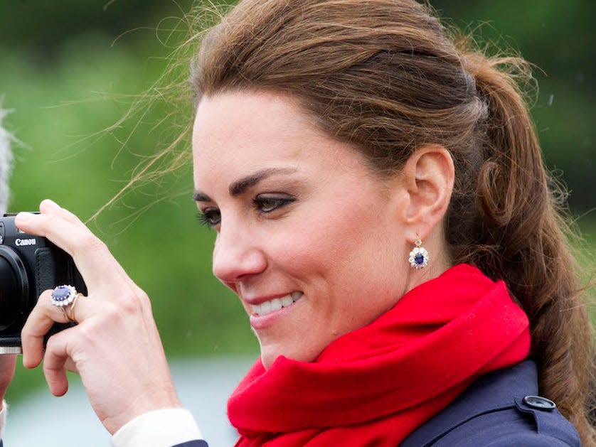 Kate Middleton wearing sapphire and diamond drop-down earrings.