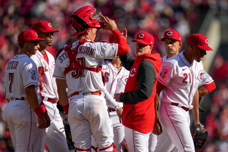 Reds Manager David Bell signals for a righthanded reliever on Opening Day.