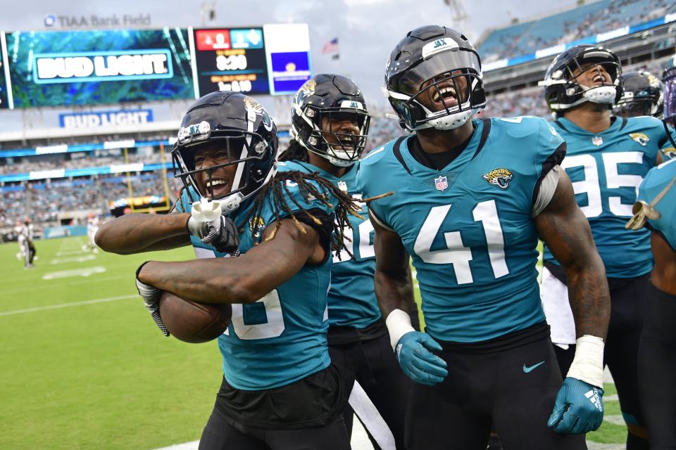 From left, Jacksonville Jaguars cornerback Shaquill Griffin (26) reacts to picking up a fumble turnover with teammates defensive tackle DaVon Hamilton (52) linebacker Josh Allen (41) and defensive end Roy Robertson-Harris (95) against the Cleveland Browns during the first quarter of a preseason NFL game Friday, Aug. 12, 2022 at TIAA Bank Field in Jacksonville. [Corey Perrine/Florida Times-Union]