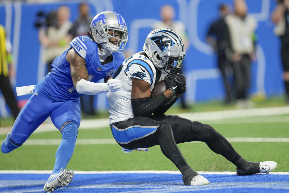 Carolina Panthers wide receiver DJ Chark Jr. (17) pulls in a touchdown reception as Detroit Lions cornerback Cameron Sutton (1) covers in the second half of an NFL football game in Detroit, Sunday, Oct. 8, 2023. (AP Photo/Paul Sancya)