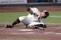 San Francisco Giants' Donovan Solano grimaces after being hit by a pitch against the Colorado Rockies during the seventh inning of a baseball game on Monday, Sept. 21, 2020, in San Francisco. (AP Photo/Tony Avelar)