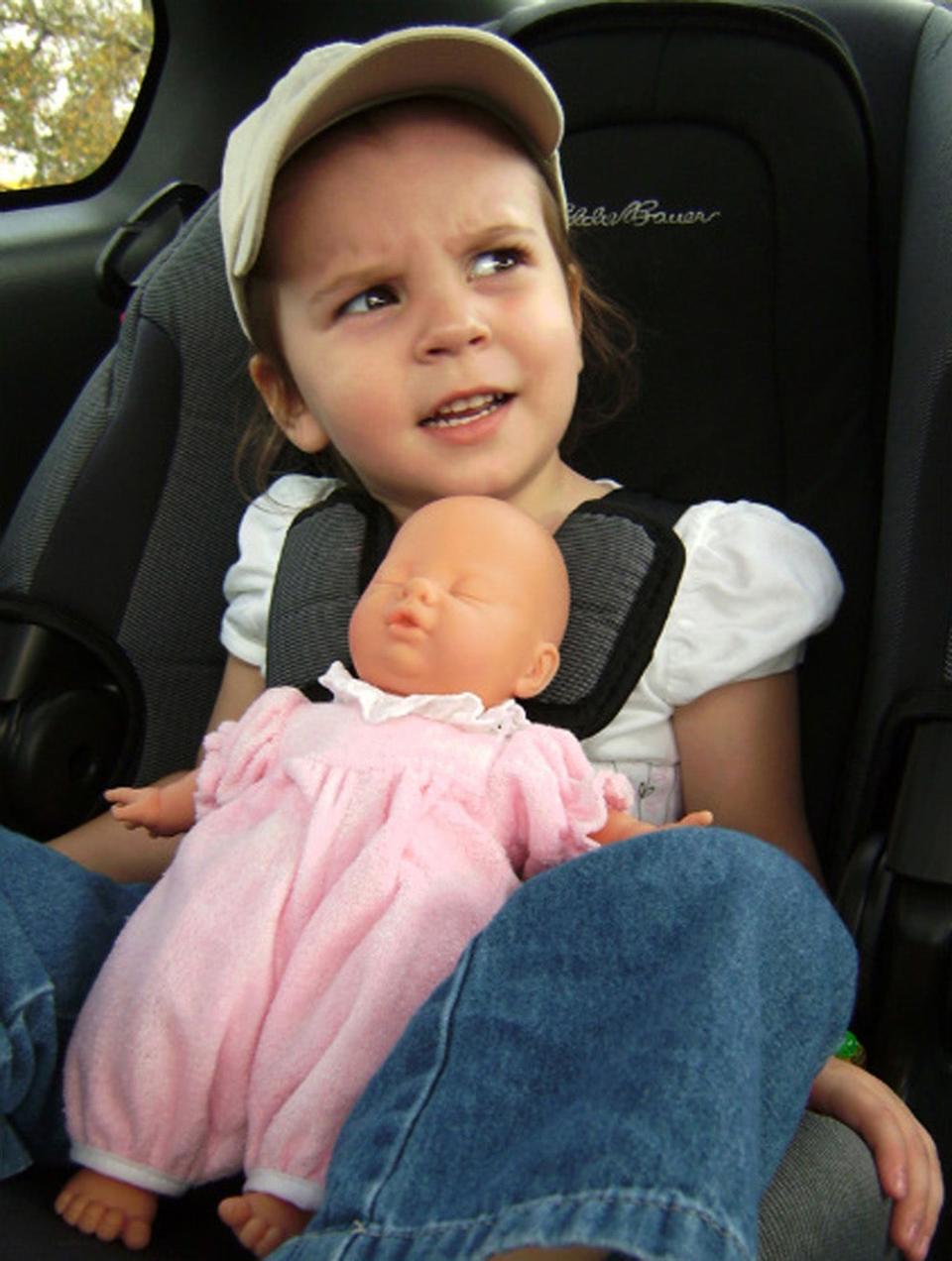 Caylee Anthony holding a baby doll