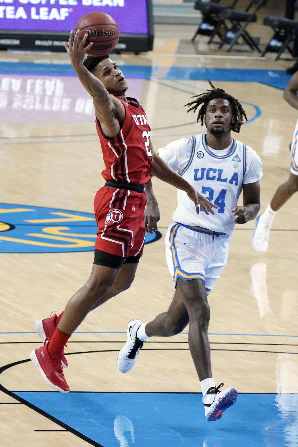 Utah guard Alfonso Plummer, left, grabs a high pass over UCLA forward Jalen Hill during the first half of an NCAA college basketball game Thursday, Dec. 31, 2020, in Los Angeles. (AP Photo/Marcio Jose Sanchez)