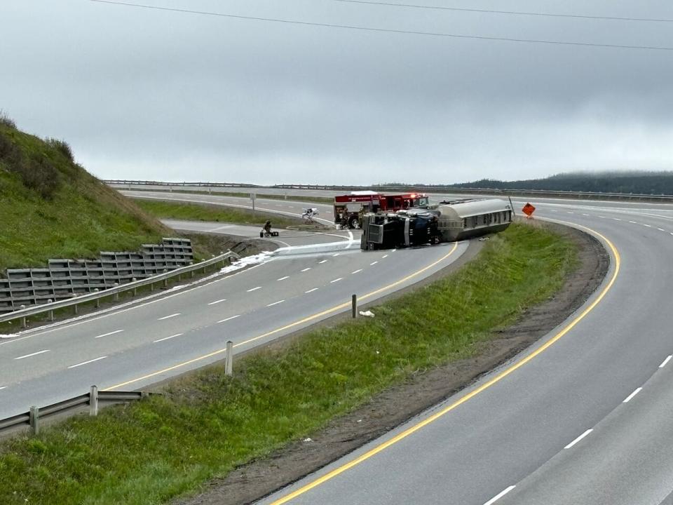 Emergency crews surround the truck as the fuel spill presents potential danger.