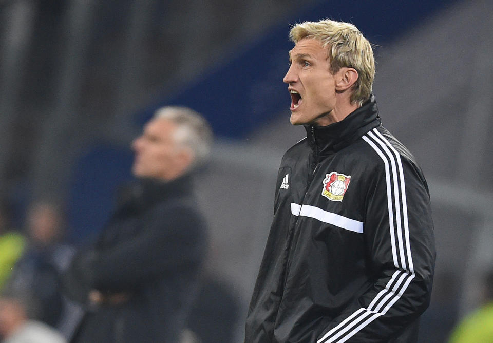 In this picture taken Friday April 4, 2014, Bayer Leverkusen coach Sami Hyypia shouts during the German first division Bundesliga soccer match between Hamburger SV and Bayer Leverkusen, in Hamburg, Germany. Bayer Leverkusen fired Sami Hyypia as coach on Saturday April 5, 2014 after an alarming run that has put Champions League qualification in doubt. Youth coach Sascha Lewandowski has been put in charge to the end of the season. The Bundesliga club said in a statement that former Liverpool defender Hyypia was being released "with immediate effect" following Friday's 2-1 loss at relegation-threatened Hamburger SV. ( (AP Photo/dpa, Marcus Brandt)